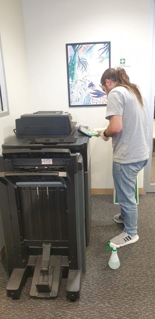 Student Cleaning Photocopier