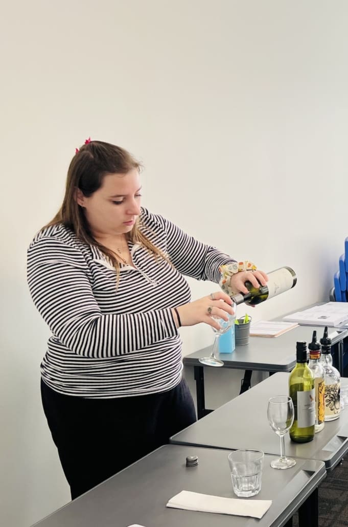 pictured student serving wine